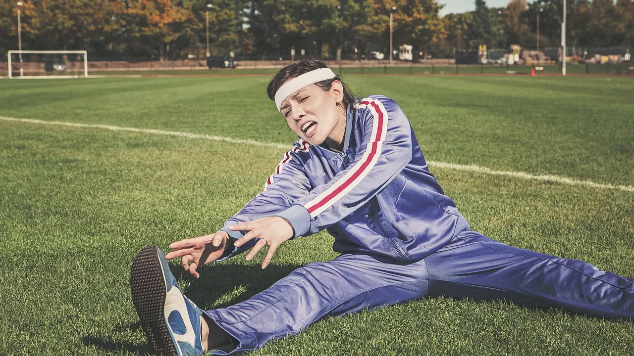 Sportif qui s’étire sur une pelouse